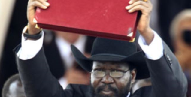 South Sudan's President Salva Kiir displays the transitional constitution of the Republic of South Sudan after signing it into law during the Independence Day celebrations in the capital Juba, July 9, 2011. AP