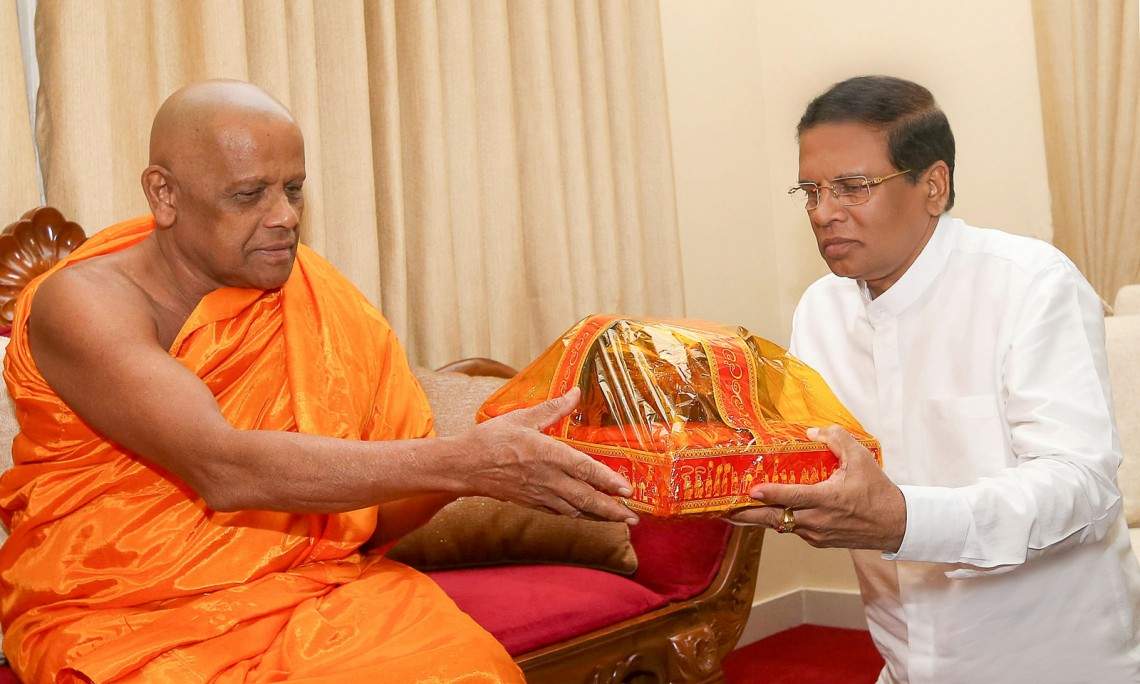 President Maithripala Sirisena with a Buddhist priest (photo credit: Colombo Page) President Maithripala Sirisena with a Buddhist priest (photo credit: Colombo Page)