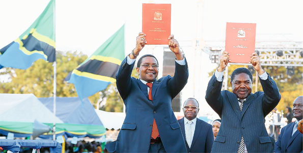 Former President Jakaya Kikwete (left) shows the draft of the constitution Former President Jakaya Kikwete (left) shows the draft of the constitution