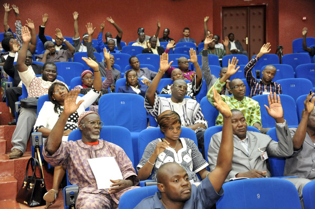 Members of Burkina Faso's interim parliament raise their hands on July 16, 2015 in Ouagadougou as they vote on a resolution asking the High Court to put deposed leader Blaise Compaore on trial for "high treason" and violating the constitution. (photo credit: AFP) Members of Burkina Faso's interim parliament raise their hands on July 16, 2015 in Ouagadougou as they vote on a resolution asking the High Court to put deposed leader Blaise Compaore on trial for "high treason" and violating the constitution. (photo credit: AFP)