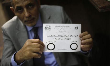 An Egyptian man displays the voting paper of a referendum on the new constitution at the Egypt Consulate in Dubai (Photo: Reuters) An Egyptian man displays the voting paper of a referendum on the new constitutio