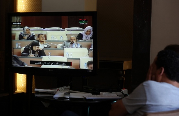 A view from the press room as reporters in Tripoli watch a live feed of Libyan members of parliament deciding between two candidates for the post of prime minister at the parliament the capital on 4 May. (AFP) (AFP)