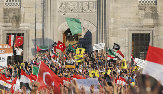 Supporters of Egypt's deposed Islamist President Mohammed Morsi and the Muslim Brotherhood wave Turkish and Egyptian flags during a rally outside of the New Mosque in Istanbul, Aug. 17, 2013. (photo by REUTERS/Murad Sezer) (photo by REUTERS/Murad Sezer)