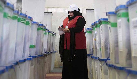 A worker from the Independent High Electoral Commission checks boxes containing ballots during vote counting in Basra, April 21, 2013. (photo by REUTERS/Atef Hassan) (photo by REUTERS/Atef Hassan)
