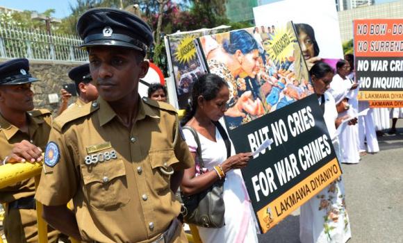 Police stand guard as activists take part in a recent demonstration against a proposed US-led UN resolution to investigate Sri Lanka for alleged war crimes outside the US embassy in Colombo. (photo credit: AFP) Police stand guard as activists take part in a recent demonstration against a proposed US-led UN resolution to investigate Sri Lanka for alleged war crimes outside the US embassy in Colombo. (photo credit: AFP)