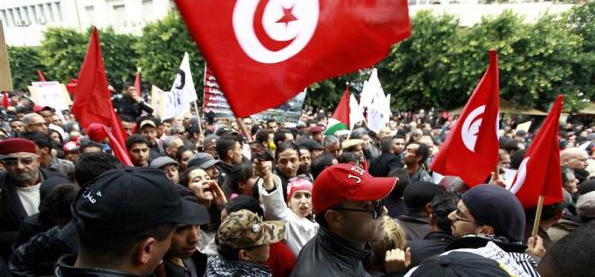 People cheer and wave national flags as they celebrate the third anniversary of autocrat Zine el-Abidine Ben Ali's downfall, in Habib Bourguiba boulevard in downtown Tunis January 14, 2014. REUTERS/Anis Mili REUTERS/Anis Mili